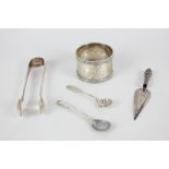 A George V silver napkin ring, a Continental white metal trowel bookmark, a pair of silver sugar