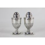 A pair of Edward VII silver peppers, maker R & S Garrard & Co, London 1905, crested, 2.5oz