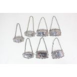 A set of four modern silver decanter labels decorated with shell and scroll borders, inscribed