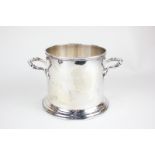 A George V silver bottle coaster, twin handled on plinth base, makers Atkin Brothers, Sheffield