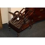 A rosewood three-division Canterbury/magazine rack with open sides and turned 'wheel' decoration,