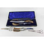 A cased horn handled three piece carving set in fitted case, and a pair of meat secateurs, and two