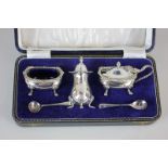 An Elizabeth II silver four piece cruet set of mustard pot, salt, pepper and two spoons, in fitted