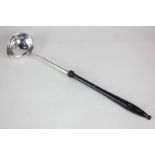 A George III silver punch ladle with turned wood handle, marks rubbed, 37cm