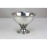 A Georg Jensen silver bowl, Louvre pattern with circular bowl and hammered decoration, on foliate