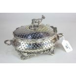A Continental silver plated butter dish, oval form with pierced decoration cast with a border and