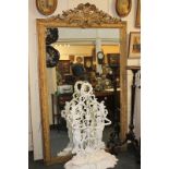 A large giltwood and gesso framed rectangular wall mirror with scrolling shield and foliate