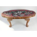 A Victorian shaped oval footstool with inset floral beadwork top, on cabriole legs, 59cm