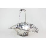 An American sterling silver basket, oval form with scroll pierced border and swing handle, stamped C