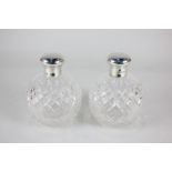 A pair of George V silver mounted cut glass scent bottles, maker H W, London 1922