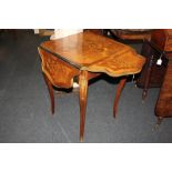 A marquetry inlaid gilt metal mounted occasional table with foliate and floral decoration, and