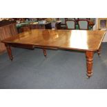 A Victorian mahogany extending dining table with two extra leaves, on baluster turned legs and