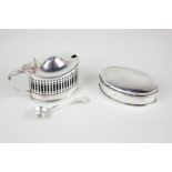 A George V silver mustard cruet, oval shape with pierced sides, blue glass liner and associated