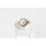 A pearl and diamond cluster ring, the pearl within a border of twelve eight cut diamonds and a