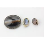 An opal doublet brooch carved with the profile of an Arab, a banded agate brooch, and a foil