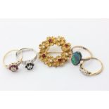 Three illusion set gem rings, a black opal doublet ring, and a gilt metal floral brooch