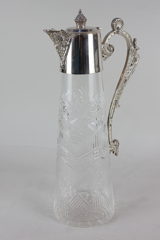 A silver plate mounted glass claret jug with cast scroll handle, 30.5cm high