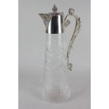 A silver plate mounted glass claret jug with cast scroll handle, 30.5cm high