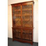 A Georgian mahogany glazed bookcase with dentil and pendant cornice and two glazed panel doors