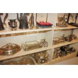 Three various silver plated tureens and covers, a circular dish and cover, two toast racks, a bottle
