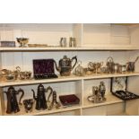 A collection of silver plated items including a hot water jug, three mugs, two sauce boats, a