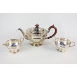 A George V silver three piece tea set, circular shape, on pedestal foot, maker Viners Ltd, Sheffield