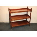 A Victorian oak three-tier buffet with open shelves, on reeded baluster supports and castors, 102cm