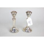 A pair of modern silver candlesticks with baluster stems and circular loaded bases, makers Sanders &