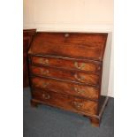 A George III mahogany bureau with fall enclosing fitted interior of small drawers and pigeon holes