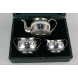 An Elkington & Co three piece silver plated tea set, beaded and fluted borders with engraved