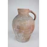 A large hand thrown pottery flagon, the inside glazed, the outside unfinished, 37cm high