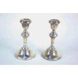 A pair of Edward VII silver candlesticks, baluster form with circular loaded bases, maker Broadway &