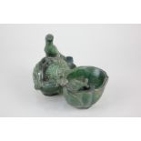 A Chinese pottery brushwater in green glaze, formed as a bird resting on a pomegranate beside a pool