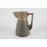 A studio pottery Arts and Crafts style jug with drip glaze, possible French mark to base, 18cm high