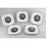 A set of five Royal Worcester Art Deco porcelain dessert plates with central floral design and black