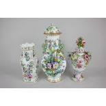 A Sitzendorf porcelain urn and cover overlaid with floral bocage decoration, together with a similar