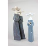 A Lladro porcelain figure group of two nuns, 34cm, and another of a single nun holding a prayer