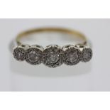 An illusion set diamond five stone ring in platinum and 18ct gold