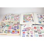 Four 20th century stamp albums containing stamps from Great Britain and around the world