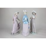A Lladro porcelain figure of a lady holding a flower, 32cm, a Nao figure of a lady raising her