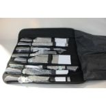 A Berghaus nine piece kitchen / chef knife and carving set, unused in packaging, in a folding bag