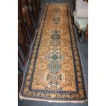 A Persian pattern wool runner rug, with central lozenge design and geometric borders, in blue, green