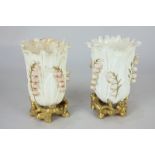 A pair of early 20th century highly decorative porcelain vases modelled as lily of the valley,