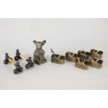 A metal pepper pot formed as a bush baby character, 10.5cm, (a/f), together with a set of six