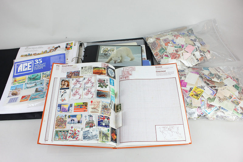 A collection of first day covers, a stamp album and loose stamps, from Great Britain and around