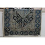 A Persian pattern wool rug, the central geometric motif within multi line borders, in pale and