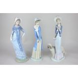 A Lladro porcelain figure of a lady with Afghan hound, 33cm, and two Nao figures of ladies wearing