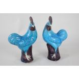 A pair of Chinese pottery chicken ornaments in blue and brown glaze, one with character stamp to