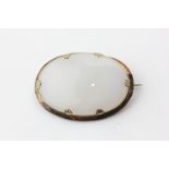 A gold mounted white hardstone brooch
