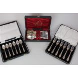 A cased set of six George V silver cake forks, Birmingham 1931, a cased set of six modern silver